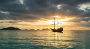 Voilier au coucher du soleil sur l'océan tropical